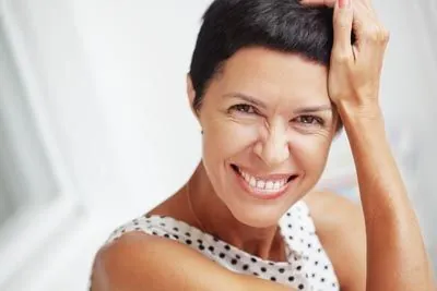 woman smiling after getting dental implants from Midtown Dental