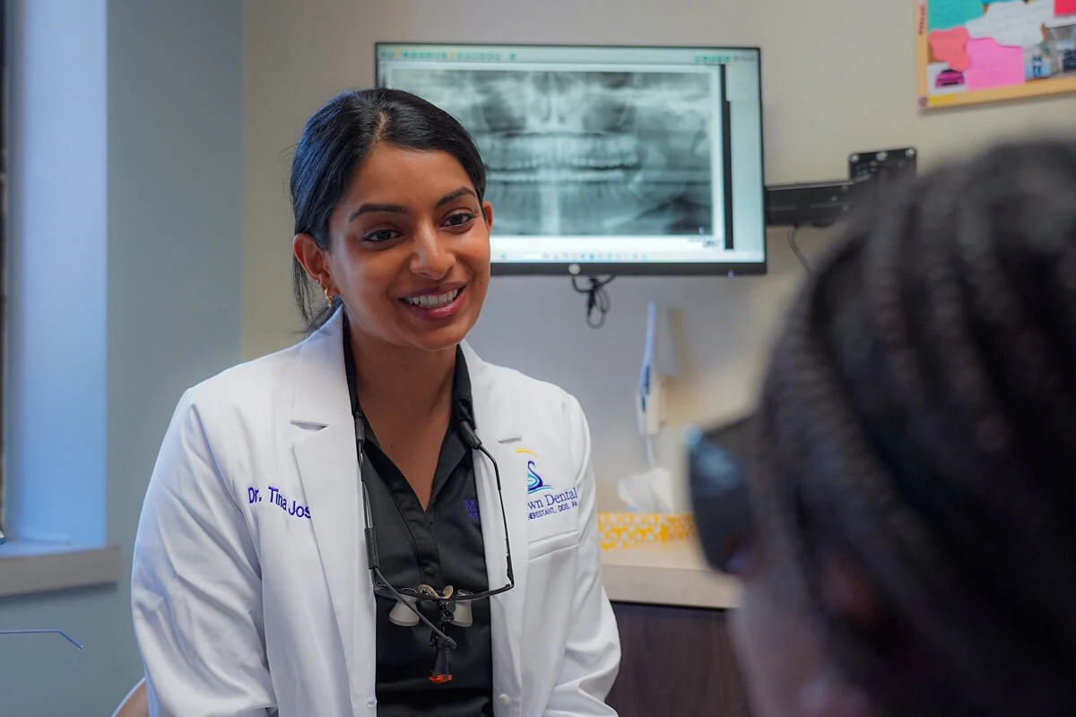 Dr. Tina Joseph giving a patient a dental implant consult in Lakeland, FL